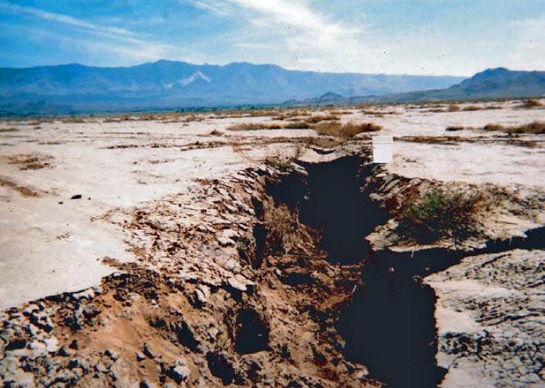Crack in ground in California from groundwater depletion.