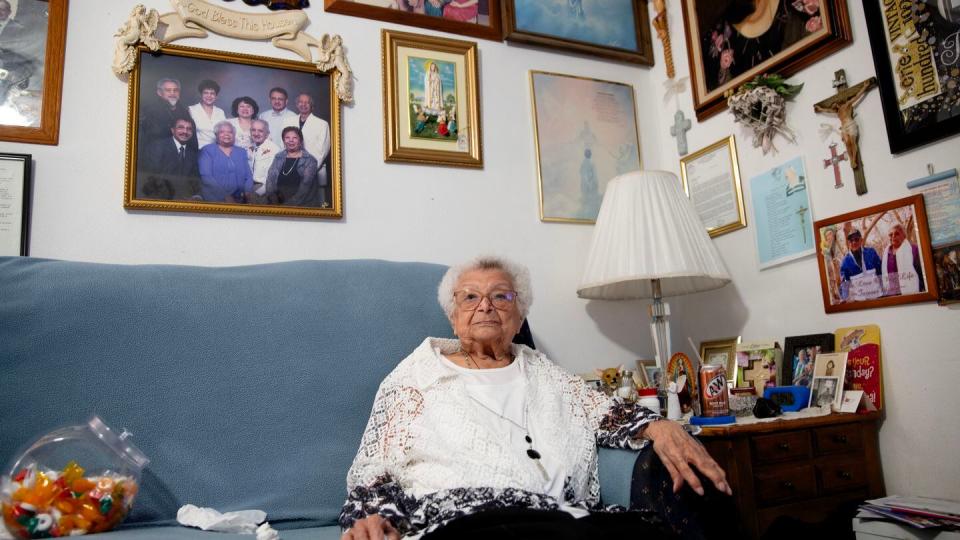 Nellie Muños, Brian Muños' grandmother, sits in her usual spot at her house. The centenarian regularly gave blessings on the street to residents and visitors alike, including Illinois Gov. J.B. Pritzker. (Zamone Perez/Staff)