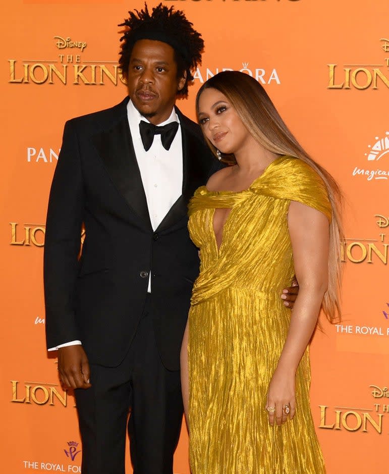 Jay-Z in a bow tie with his arm around Beyoncé's waist on the red carpet