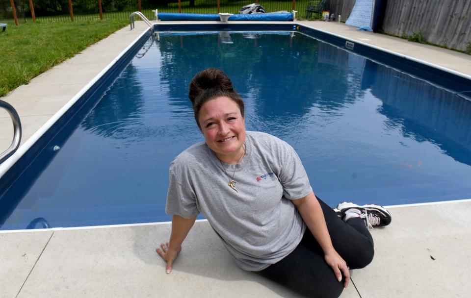 Andrea Johns of Lawrence Township sits by her swimming pool, which she rents by the hour through Swimply.