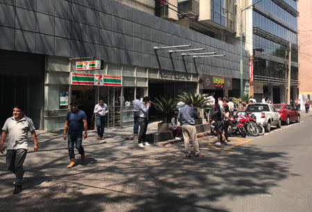 People stand outside a building after an earth quake in Mexico City, Mexico April 22, 2019. REUTERS/Carlos Jasso