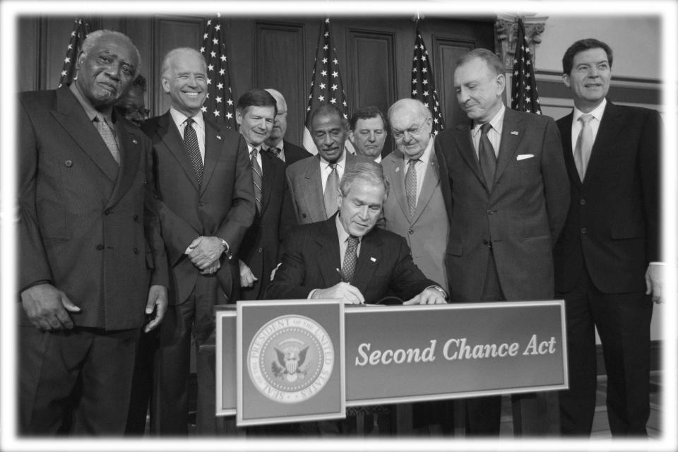 President George W. Bush, center, signs the Second Chance Act in 2008. (Photo: Gerald Herbert/AP; digitally enhanced by Yahoo News)