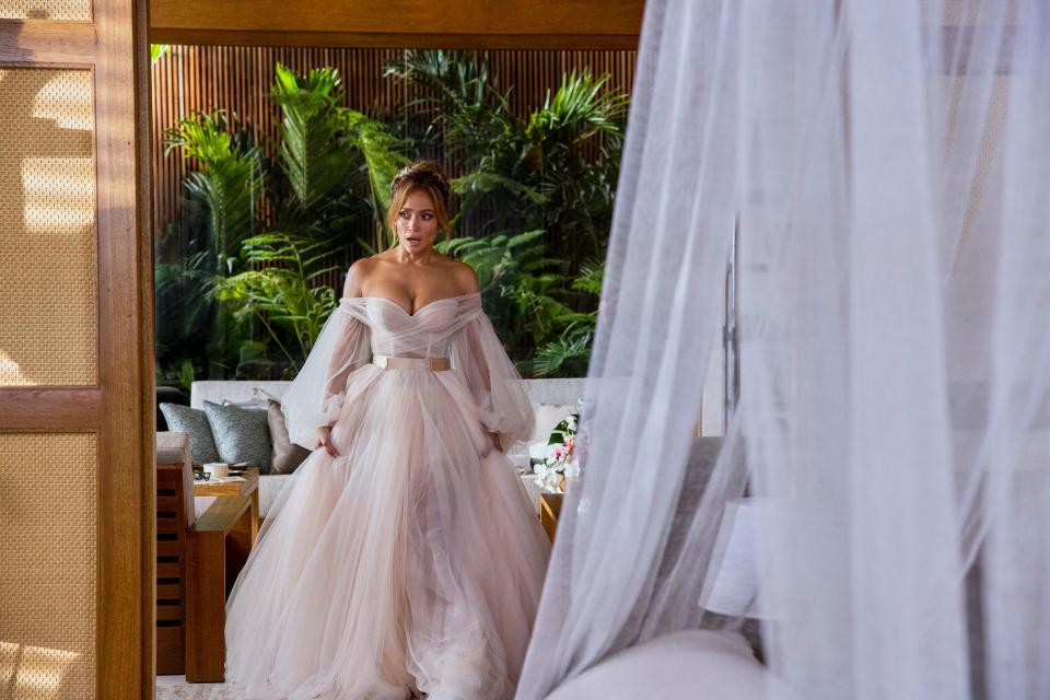 Jennifer Lopez stands in a wedding dress on the set of "Shotgun Wedding."