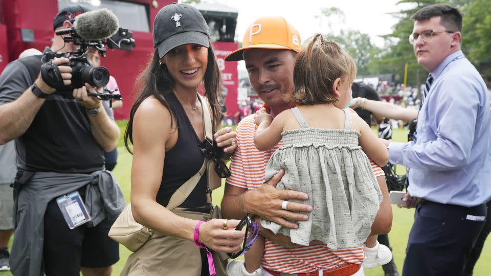 Fowler walks off the 18th green with his wife Allison and daughter Maya after the final round. - Carlos Osorio/AP