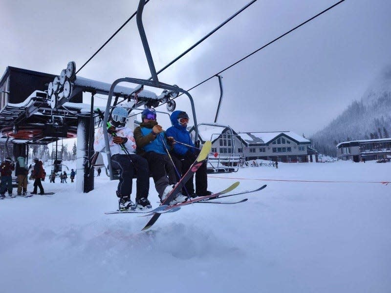 Skiers ride on a ski lift at Hoodoo Ski Area's opening day on Wednesday, Jan. 10, 2024.