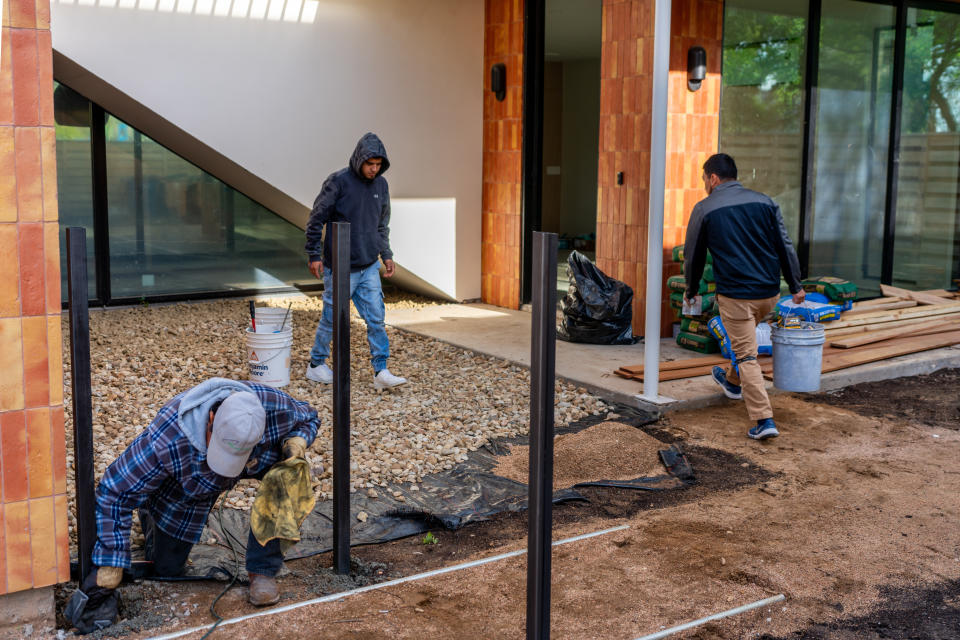 Workers renovate a newly constructed home on March 19, 2024 in Austin, Texas. (Credit: Brandon Bell, Getty Images)