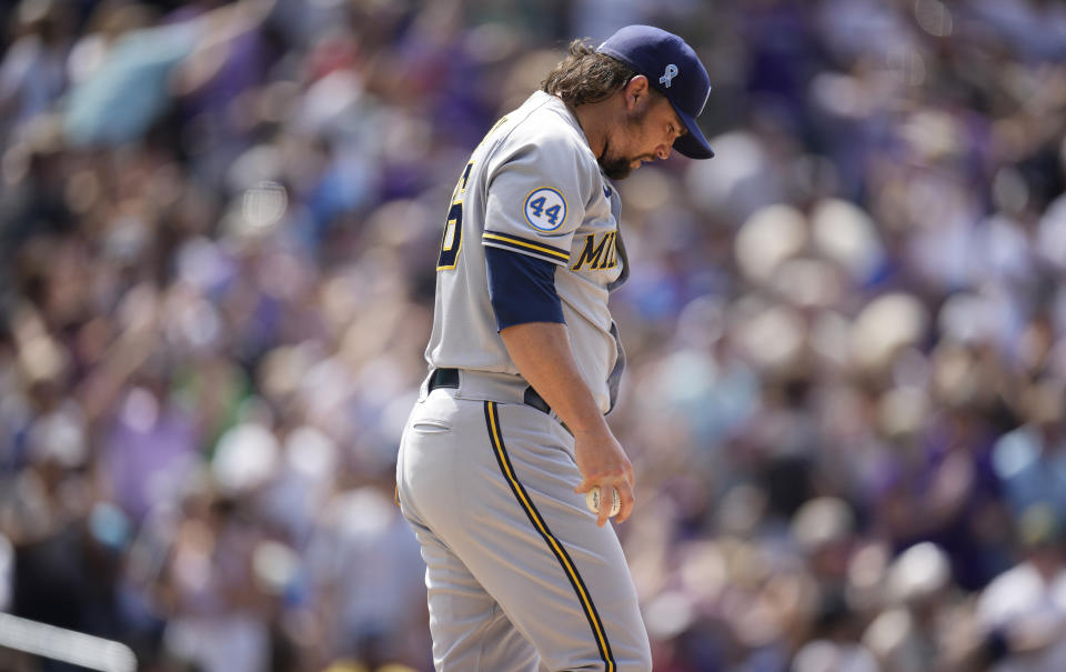 Milwaukee Brewers relief pitcher Zack Godley reacts after giving up a solo home run to Colorado Rockies' Joshua Fuentes in the sixth inning of a baseball game Sunday, June 20, 2021, in Denver. (AP Photo/David Zalubowski)