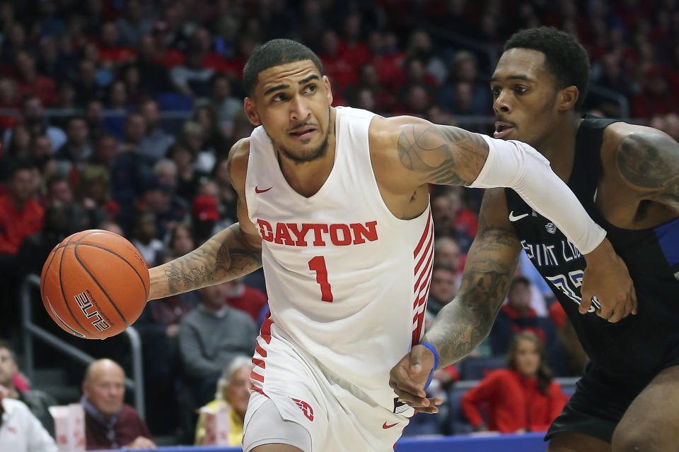 FILE - In this Feb 1, 2020, file photo, Dayton's Obi Toppin (1) drives to the basket against St. Louis forward Jimmy Bell Jr. (32) during the second half of an NCAA college basketball game in Dayton, Ohio. Toppin was voted the AP men's college basketball player of the year, Tuesday, March 24, 2020. (AP Photo/Tony Tribble, File)