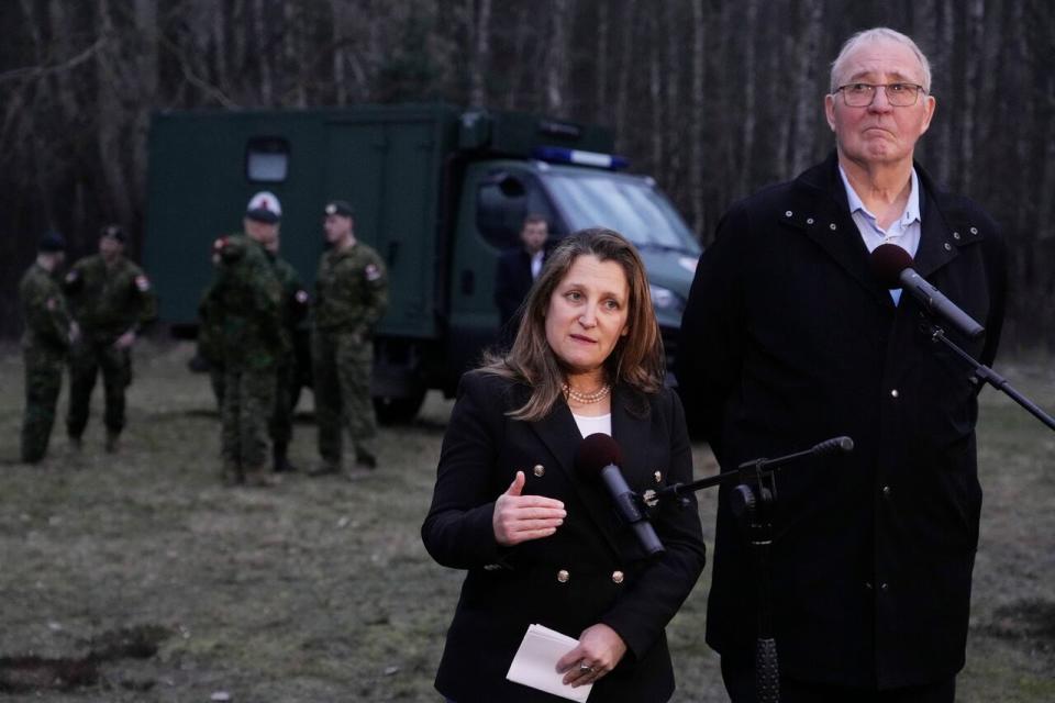 Deputy Prime Minister Chrystia Freeland, left, and Defence Minister Bill Blair talk to the media during a joint exercise in which Polish and Canadian troops provide training to soldiers from Ukraine near Jezewo, central Poland, on Sunday, Feb. 25, 2024.