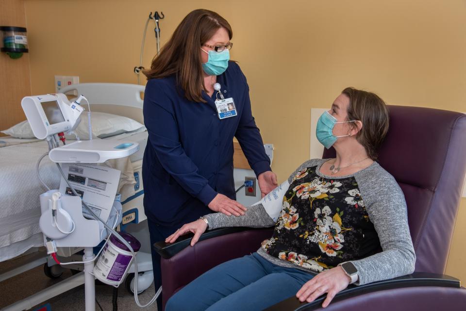 Nurse Manager Teresa Caouette, RN, talks with a patient in one of the 15 private patient rooms in the new inpatient Acute Rehabilitation Center at Frisbie Memorial Hospital.