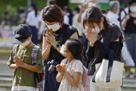 People pray at the Atomic Bomb Hypocenter Park on the 77th anniversary of the atomic bombing in Nagasaki, southern Japan, Tuesday, Aug. 9, 2022. (Kyodo News via AP)