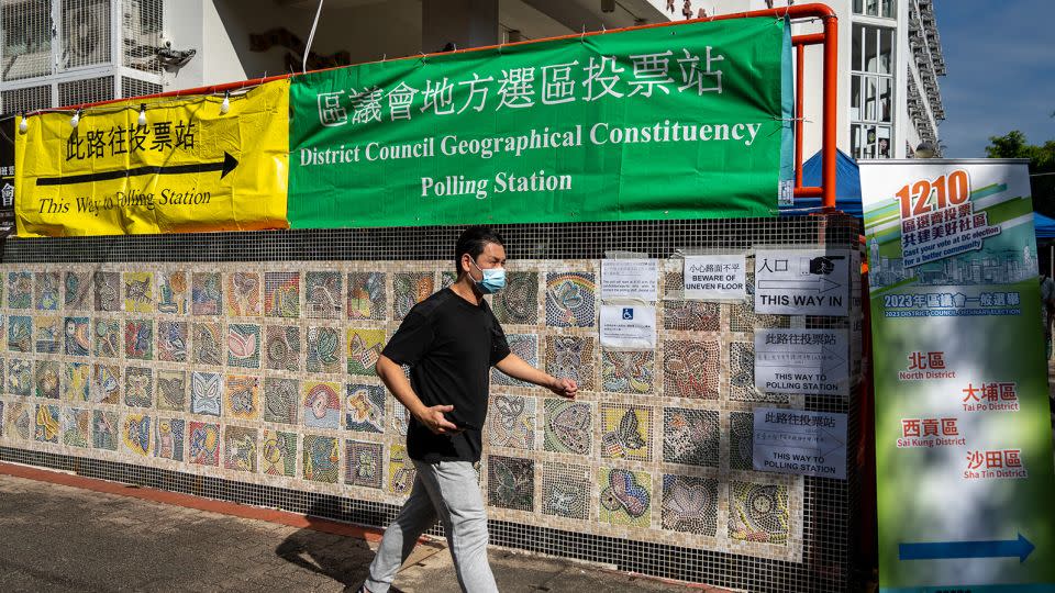 A man walks towards a polling station for the district council elections in Hong Kong on December 10, 2023. - Vernon Yuen/NurPhoto/Getty Images