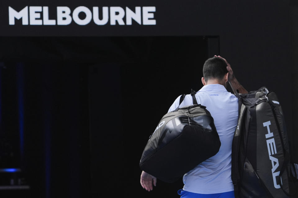 Novak Djokovic of Serbia walks from Rod Laver Arena following his loss to Jannik Sinner of Italy in their semifinal at the Australian Open tennis championships at Melbourne Park, Melbourne, Australia, Friday, Jan. 26, 2024. (AP Photo/Andy Wong)