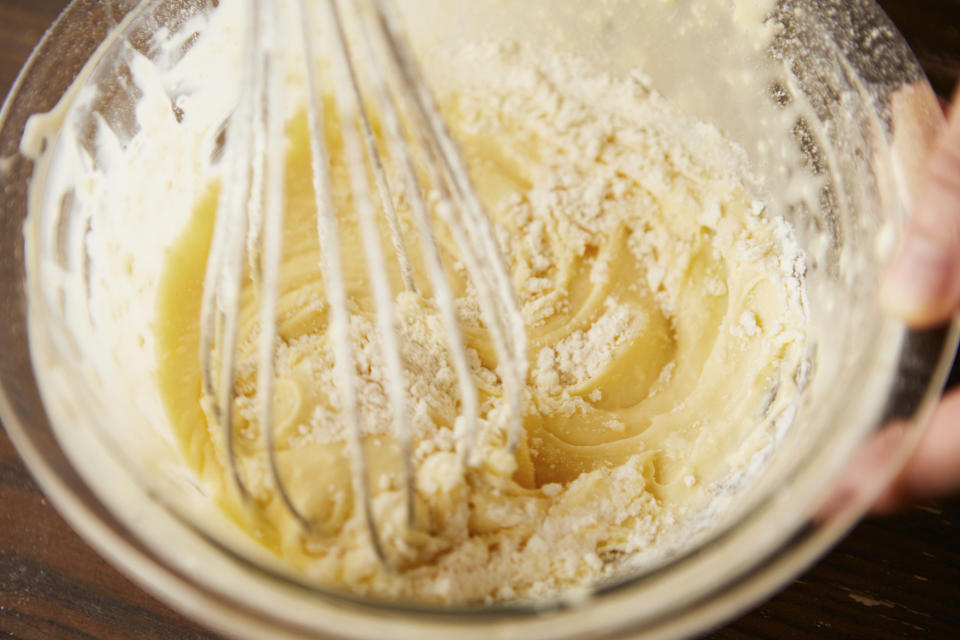 Cake batter in a bowl on a wooden table.