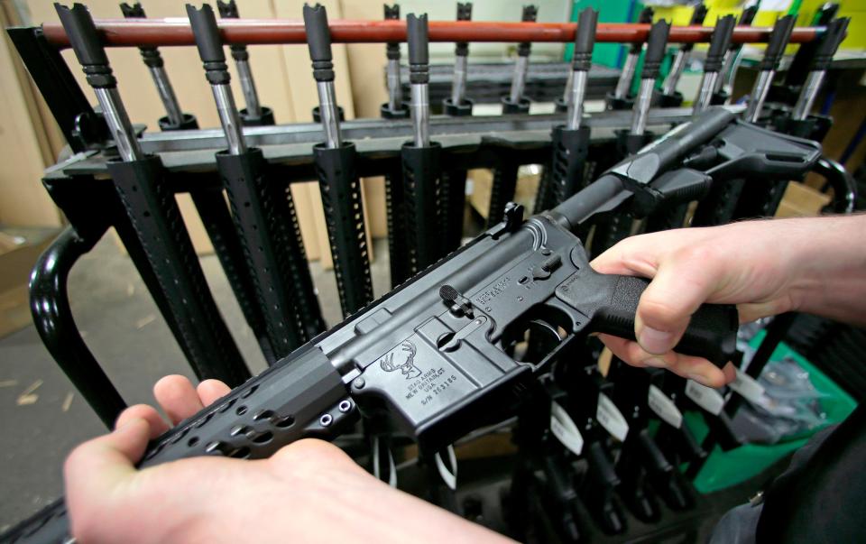 A photo taken April 10, 2013 shows craftsman Veetek Witkowski holding a newly assembled AR-15 rifle at the Stag Arms company in New Britain, Connecticut. A ruling released Friday, April 6, 2018, by a federal judge in Boston, dismissed a lawsuit challenging Massachusetts' ban on assault weapons and large-capacity magazines, stating that assault weapons are beyond the scope of the Second Amendment right to "bear arms."