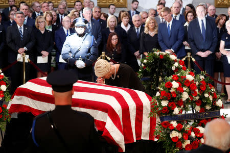 Cindy McCain, wife of late U.S. Senator John McCain, kneels at her husband's casket during ceremonies honoring Senator McCain inside the U.S. Capitol Rotunda in Washington, U.S., August 31, 2018. REUTERS/Kevin Lamarque