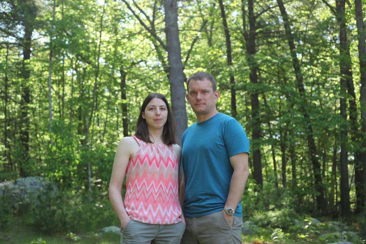 In May 2022, Bonnie and Chris Dibble stand on their Johnston property abutting Green Development's proposed solar farm. Last year, they moved to North Carolina and sold their house to Green when a potential buyer pulled out of the deal – after the developer cleared dozens of trees on land it owned around the Dibbles' lot.