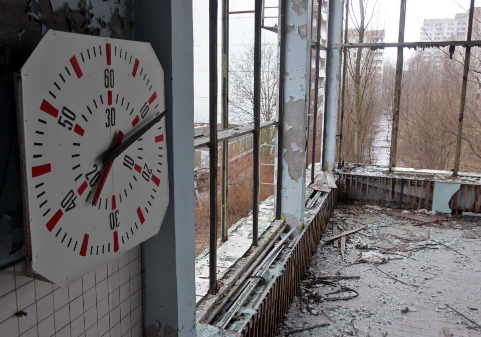 A clock is seen on a wall at a swimming pool in Ukraine's ghost town of Pripyat, which was evacuated after the Chernobyl nuclear disaster, April 13, 2006. Ukraine prepares to mark the 20th anniversary of the world's worst nuclear disaster, when a reactor at the Chernobyl plant exploded, spreading a radioactive cloud across Europe and the Soviet Union.   REUTERS/Gleb Garanich