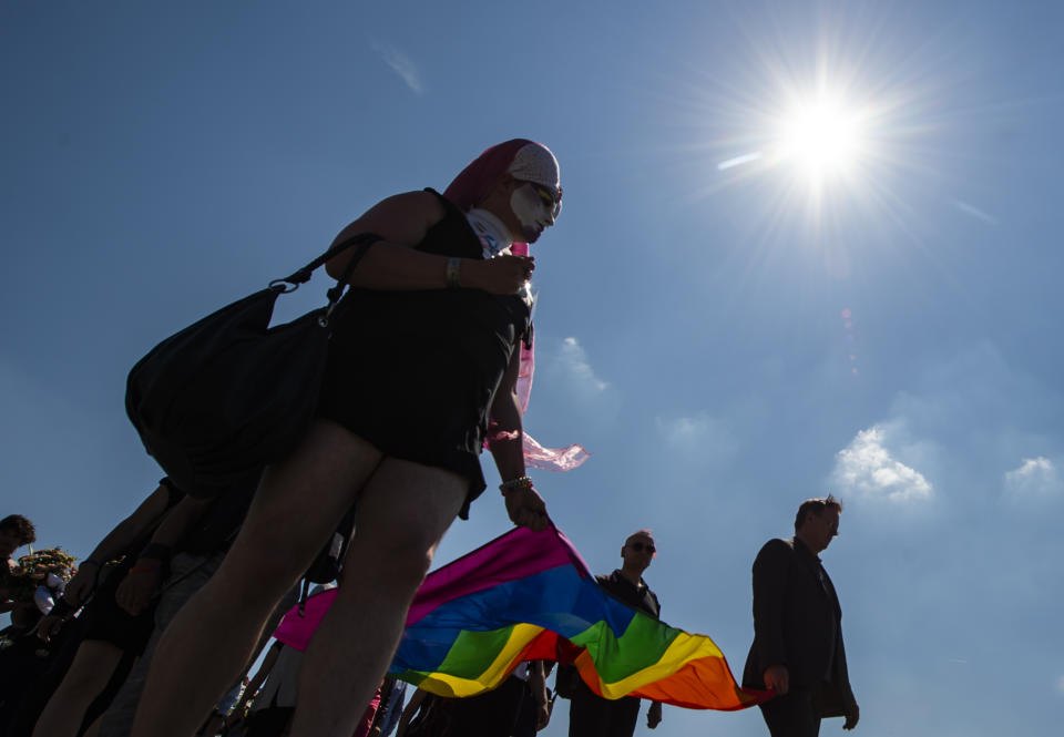 People carry a rainbow flag in remembrance for prisoners assigned a pink triangle in the former Nazi concentration camp Buchenwald within the Christopher Street Day in Weimar, Germany, Sunday, June 23, 2019. There were 650 prisoners assigned a pink triangle in the Buchenwald concentration camp between 1937 and 1945. Many of them lost their lives. (AP Photo/Jens Meyer)