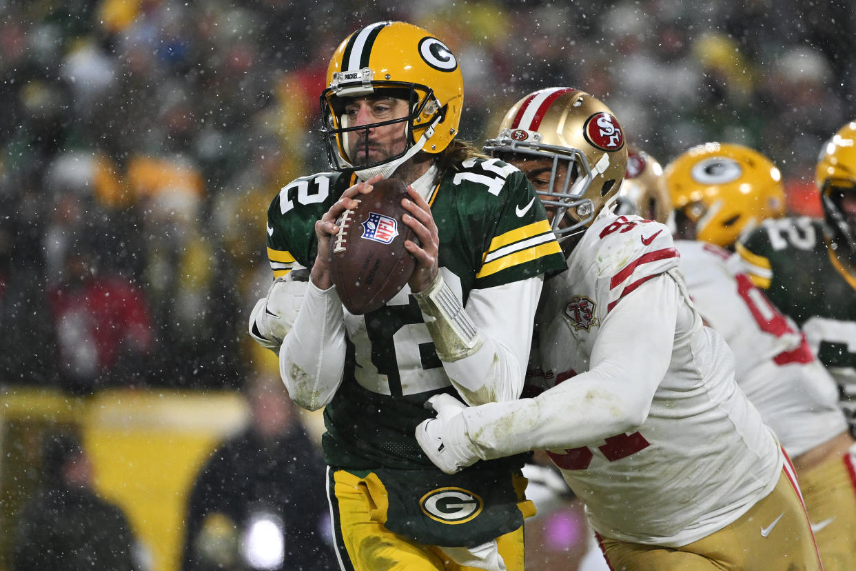 GREEN BAY, WISCONSIN - JANUARY 22:  Quarterback Aaron Rodgers #12 of the Green Bay Packers is sacked by defensive end Arik Armstead #91of the San Francisco 49ers during the 2nd quarter of the NFC Divisional Playoff game against the San Francisco 49ers at Lambeau Field on January 22, 2022 in Green Bay, Wisconsin. (Photo by Quinn Harris/Getty Images)