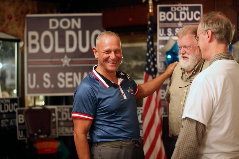 New Hampshire Republican U.S. Senate candidate Don Bolduc chats with supporters during a primary night campaign gathering, Tuesday Sept. 13, 2022, in Hampton, N.H. (AP Photo/Reba Saldanha)