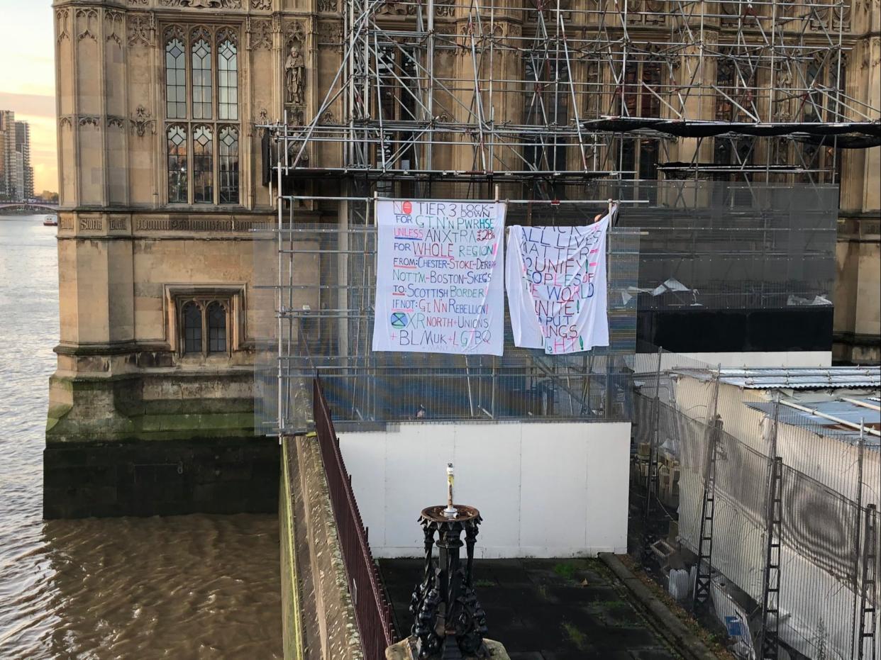 Banners displayed by activist on Big Ben’s scaffolding, photographed by a passerby (Lita Zalite)