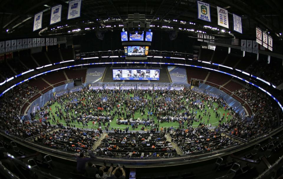 Reporters crowd the floor of the Prudential Center during media day for the NFL Super Bowl XLVIII football game Tuesday, Jan. 28, 2014, in Newark, N.J. (AP Photo/Charlie Riedel)
