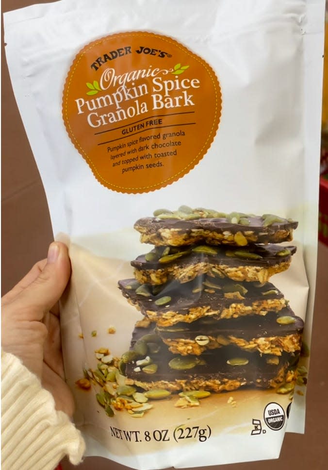 hand holding bag of trader joes pumpkin spice granola bark