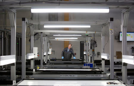 A production operator checks a panel at the SolarWorld solar panel factory in Hillsboro, Oregon, U.S, January 15, 2018. Picture taken January 15, 2018 REUTERS/Natalie Behring