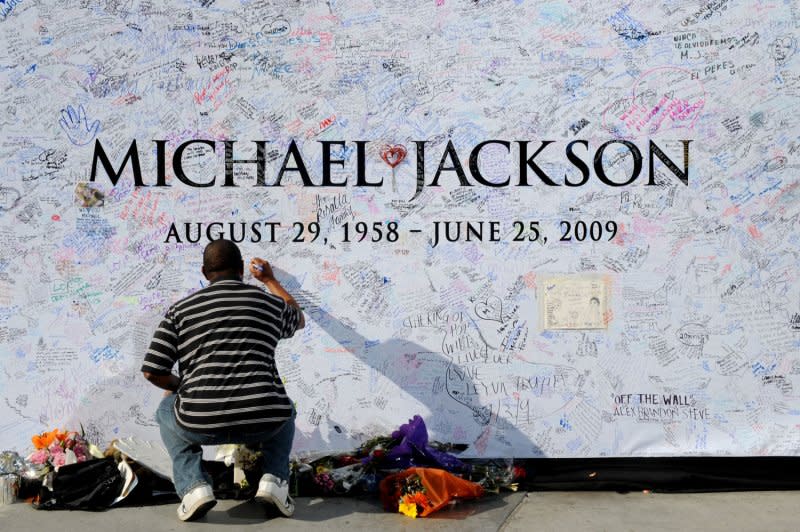 A fan signs a large poster at the Staples Center in Los Angeles on July 6, 2009. The venue was the planned location for late pop star Michael Jackson's memorial service scheduled for July 7, 2009. Photo by Jim Ruymen/UPI