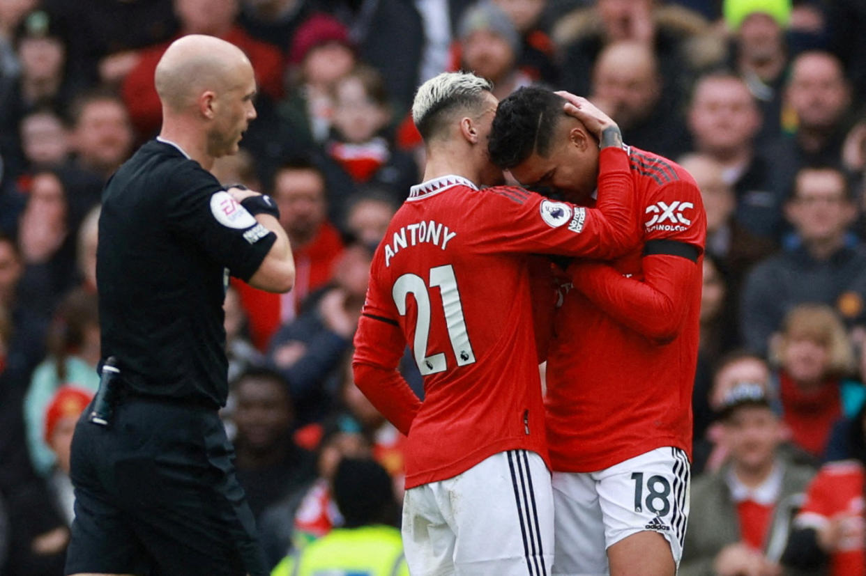 A distraught Manchester United midfielder Casemiro (left) is being consoled by teammate Antony after he was shown a straight red card against Southampton in the English Premier League.