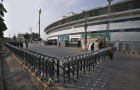 Pakistan paramilitary troops and police officer stand guard outside the Pindi Cricket Stadium following canceling of 1st one day international cricket match between Pakistan and New Zealand, in Rawalpindi, Pakistan, Friday, Sept. 17, 2021. New Zealand abandoned its cricket tour of Pakistan over security concerns that mystified the hosts, just before the Black Caps' first scheduled match in Pakistan in 18 years. (AP Photo/Anjum Naveed)