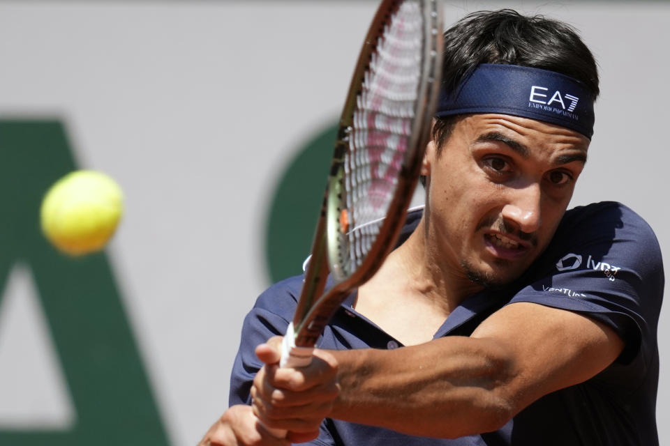 Italy's Lorenzo Sonego plays a shot against Russia's Karen Khachanov during their fourth round match of the French Open tennis tournament at the Roland Garros stadium in Paris, Sunday, June 4, 2023. (AP Photo/Christophe Ena)