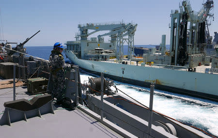 A sailor on board the Royal Australian Navy frigate HMAS Stuart watches as the Royal Canadian Navy vessel MV Asterix pulls alongside during Australia's largest maritime exercise 'Exercise Kakadu' being conducted off the coast of Darwin in northern Australia, September 7, 2018. Picture taken September 7, 2018. REUTERS/Jill Gralow