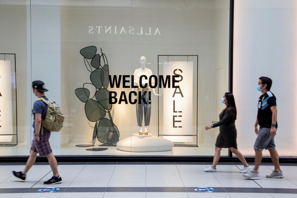 People walk in the Eaton Centre shopping mall, as the provincial phase 2 of reopening from the coronavirus disease (COVID-19) restrictions begins in Toronto, Ontario, Canada June 24, 2020. REUTERS/Carlos Osorio