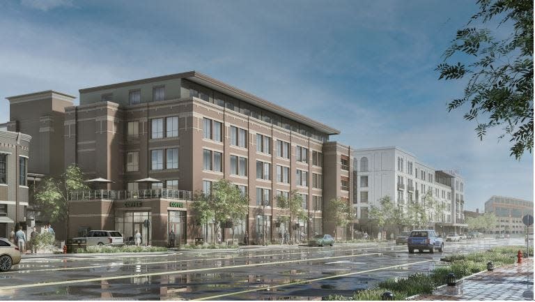 Looking north from Michigan Street, this photo rendering shows plans for the new Madison Lifestyle District that will replace two parking lots south of Memorial Hospital in downtown South Bend. An apartment building is in the foreground with a 100-room hotel in the background.