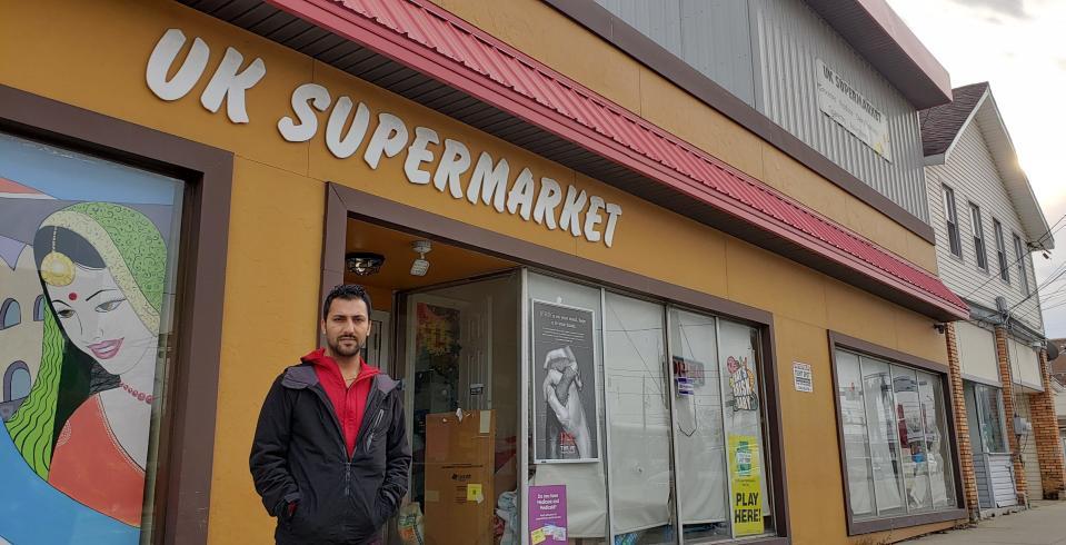 Pradip Upreti, 33, is the co-owner of the UK Supermarket, 1105 Parade St., which opened in May 2013 and is within the footprint of the multimillion-dollar East Side Renaissance initiative, which looks to revamp a portion of Parade Street. Upreti - a former Bhutanese refugee who is now a naturalized U.S. citizen - believes both businesses and residents could greatly benefit from the ESR project.  He was photographed on Jan. 11, 2023.