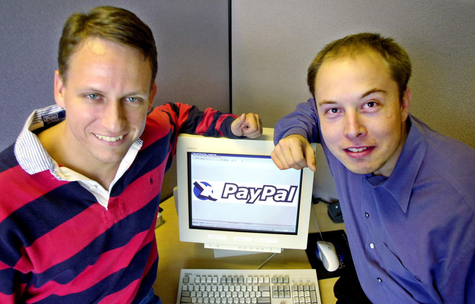 PayPal Chief Executive Officer <span class="caas-xray-inline-tooltip"><span class="caas-xray-inline caas-xray-entity caas-xray-pill rapid-nonanchor-lt" data-entity-id="Peter_Thiel" data-ylk="cid:Peter_Thiel;pos:2;elmt:wiki;sec:pill-inline-entity;elm:pill-inline-text;itc:1;cat:BusinessPerson;" tabindex="0" aria-haspopup="dialog"><a href="https://search.yahoo.com/search?p=Peter%20Thiel" data-i13n="cid:Peter_Thiel;pos:2;elmt:wiki;sec:pill-inline-entity;elm:pill-inline-text;itc:1;cat:BusinessPerson;" tabindex="-1" data-ylk="slk:Peter Thiel;cid:Peter_Thiel;pos:2;elmt:wiki;sec:pill-inline-entity;elm:pill-inline-text;itc:1;cat:BusinessPerson;" class="link ">Peter Thiel</a></span></span>, left, and founder Elon Musk, right, pose with the PayPal logo at corporate headquarters in Palo Alto, Calif. on Oct. 20, 2000.<span class="copyright">Paul Sakuma—AP</span>