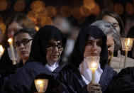 <p>Faithful hold candles at the Sanctuary of Our Lady of Fatima, May 12, 2017, in Fatima, Portugal. Pope Francis will canonize on Saturday two poor, illiterate shepherd children whose visions of the Virgin Mary 100 years ago marked one of the most important events of the 20th-century Catholic Church. (Photo: Alessandra Tarantino/AP) </p>