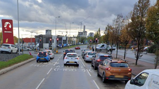 Cars and a van lined up in lanes ahead of traffic lights on Albion Way in Salford