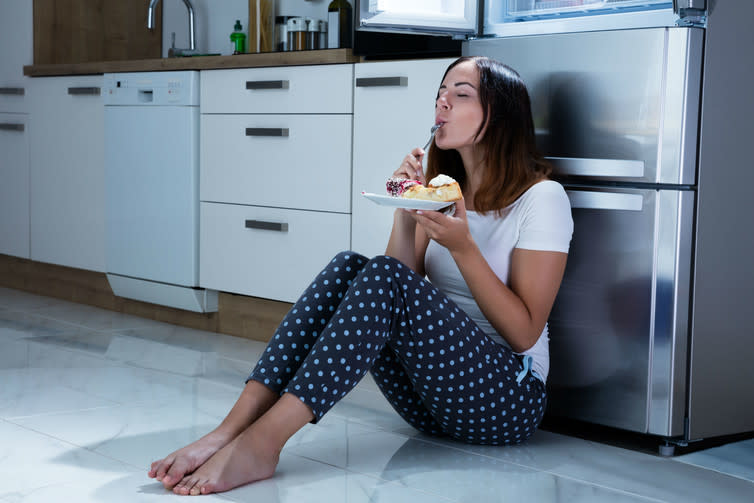 <span class="caption">Just one bite…</span> <span class="attribution"><a class="link " href="https://www.shutterstock.com/image-photo/woman-eating-near-refrigerator-566250478?src=ID7UQByfsleJe4HSCWMdXw-2-24" rel="nofollow noopener" target="_blank" data-ylk="slk:Andrey_Popov/Shutterstock;elm:context_link;itc:0;sec:content-canvas">Andrey_Popov/Shutterstock</a></span>