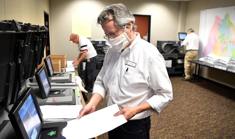 Bill Vinett scans absentee ballots into the Election Commission system for counting in Nashville, Tennessee. Thursday, August 6, 2020 