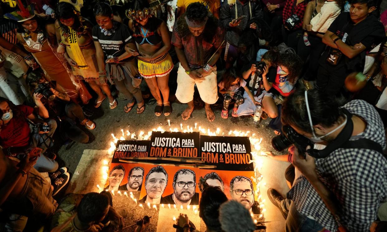 <span>Indigenous people and human rights activists attend a vigil for justice in 2022 over the deaths of environmental journalist Dom Phillips and indigenous expert Bruno Pereira.</span><span>Photograph: André Penner/AP</span>