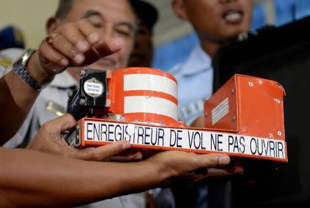 Indonesian soldiers hold the cockpit voice recorder of AirAsia QZ8501 at Iskandar airbase in Pangkalan Bun, Central Kalimantan January 13, 2015. REUTERS/Prasetyo Utomo/Antara Foto