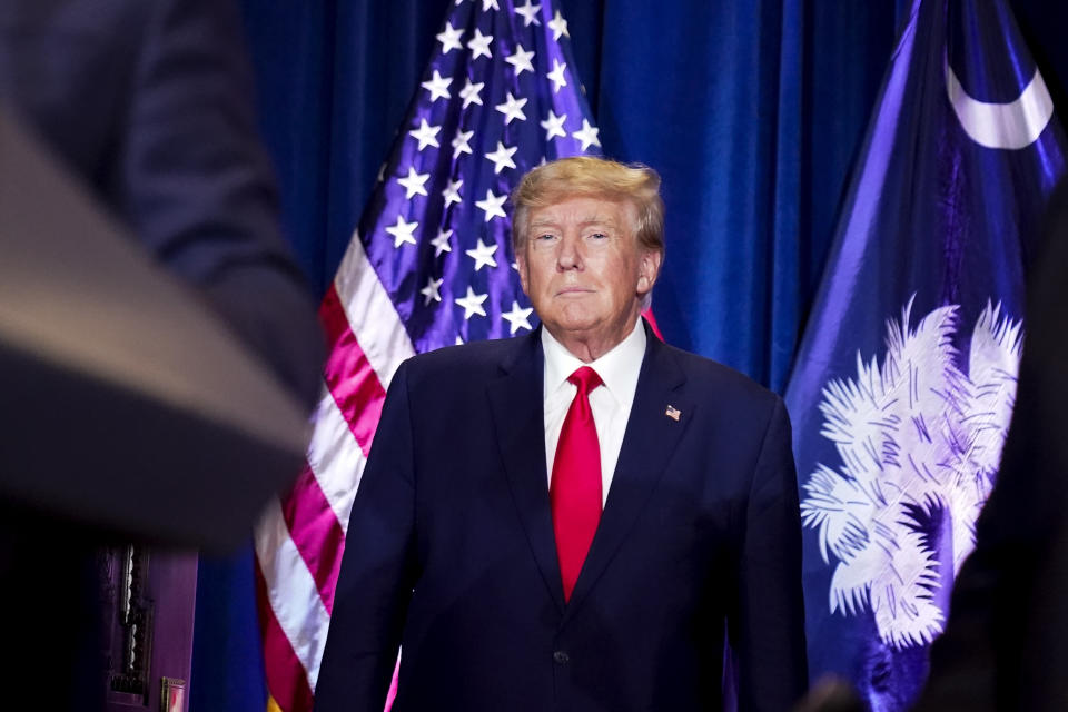 FILE - Former President Donald Trump listens as he is introduced to speak at the South Carolina Statehouse, Jan. 28, 2023, in Columbia, S.C. (AP Photo/Alex Brandon, File)