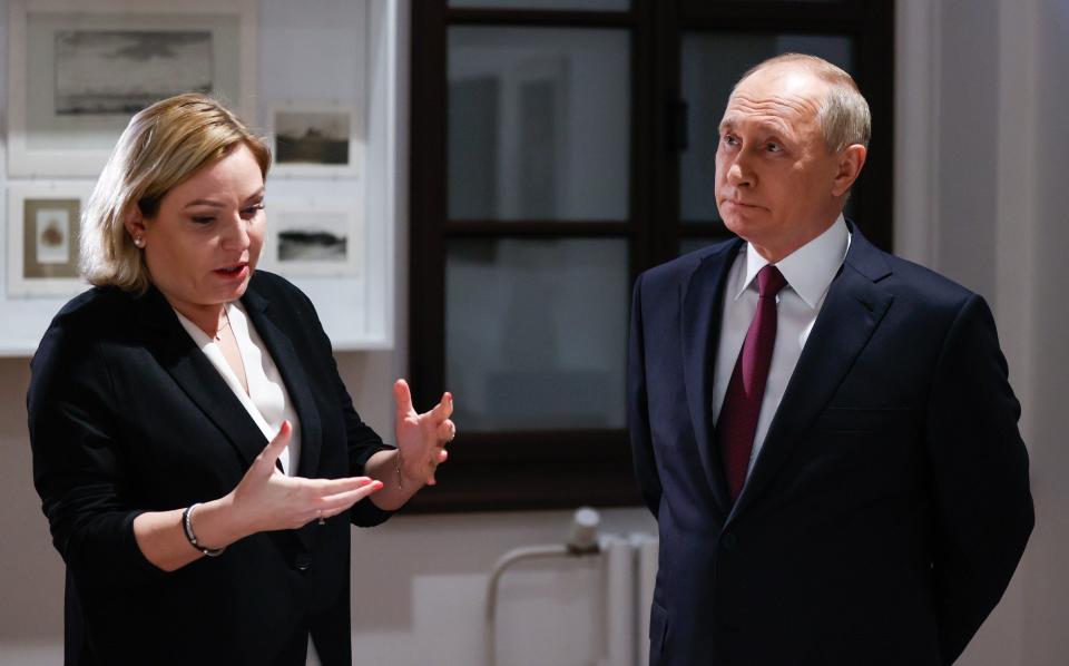 Vladimir Putin (R) and Olga Lyubimova visit the Dostoevsky House Museum opened after restoration to mark the Russian novelist's 200th birthday. The museum's location is the north annex of the former Mariinsky Hospital for the Poor, where Dostoevsky spent his childhood and adolescence