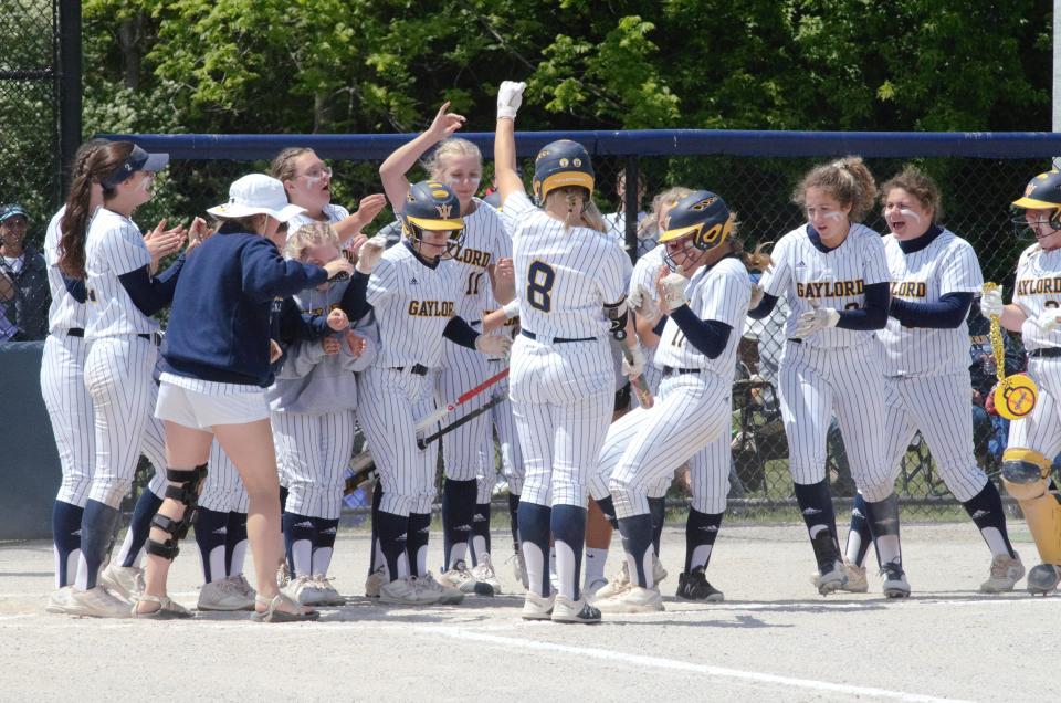 Gaylord softball celebrates as Jayden Jones crosses the plate after her leadoff home run during the district championship game on Saturday, June 4 at Petoskey High School.