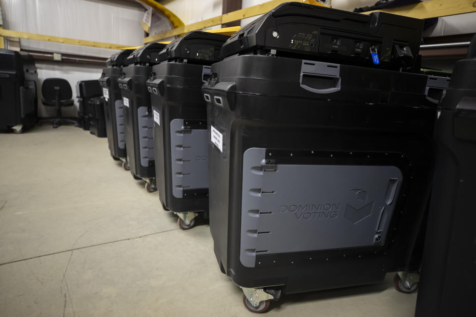 FILE - Dominion Voting Systems ballot-counting machines are lined up at a Torrance County warehouse during testing of election equipment with local candidates and partisan officers in Estancia, N.M., Sept. 29, 2022. The Delaware judge overseeing the voting machine company's $1.6 billion defamation lawsuit against Fox News announced late Sunday, April 16, that he was delaying the start of the trial until Tuesday, April 18. He did not cite a reason. The trial, which has drawn international interest, had been scheduled to start Monday morning with jury selection and opening statements. (AP Photo/Andres Leighton, File)