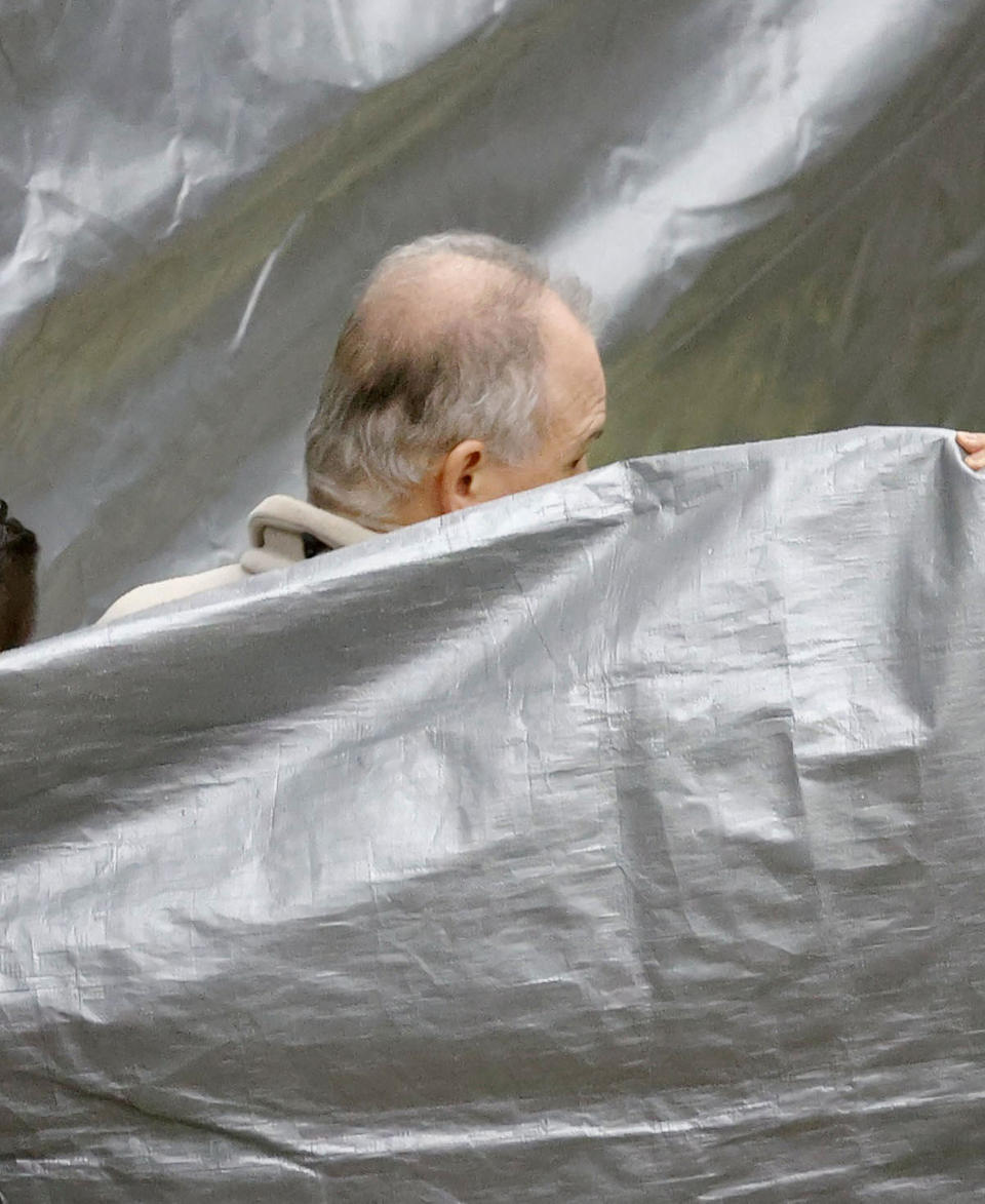 A man who appears to be Michael Taylor, arrives at Narita Airport in Narita, east of Tokyo, Tuesday, March 2, 2021. Two Americans suspected of helping former Nissan Chairman Carlos Ghosn skip bail and escape to Lebanon in December 2019 have been extradited to Japan. Taylor and his son Peter had been held in a suburban Boston jail since May. They were handed over to Japanese custody on Monday and were due to arrive in Tokyo on Tuesday. (Sadayuki Goto/Kyodo News via AP)