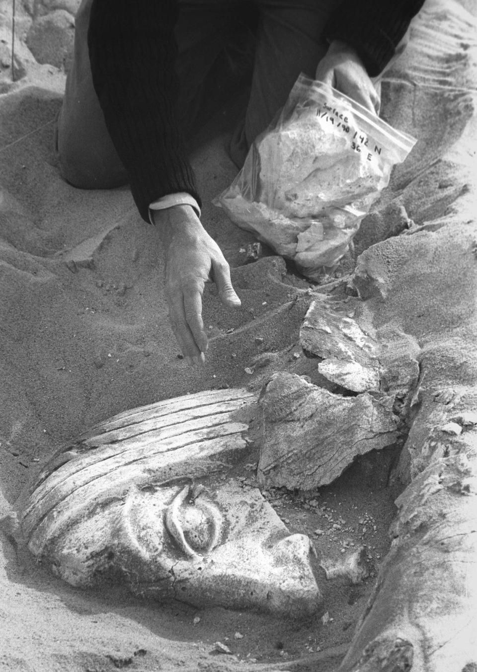 Glen Wharton, gestures over a dig exposing a piece of bas relief plaster set from the Ten Comandments, the 1923 black and white version of the film by Cecil B. DeMille filmed in the Guadalupe Dunes. He was part of a team working on an archeological investigation of the fragile site Nov. 19, 1990.